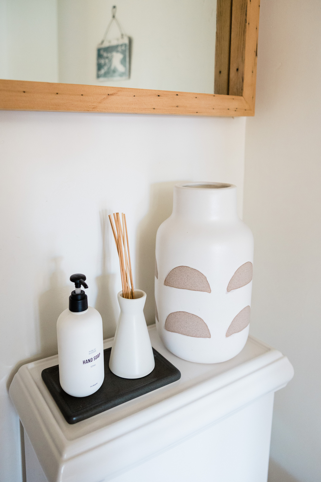 Bottle of Hand Soap and Vases in the Bathroom